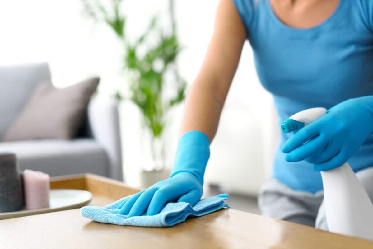 Woman cleaning a table at home